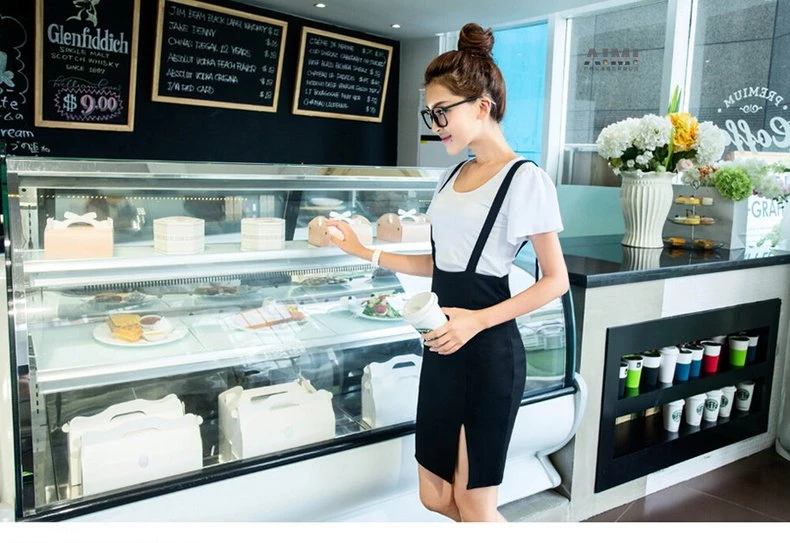 White top and black high-waist suspender skirt at cafe counter, soft daylight