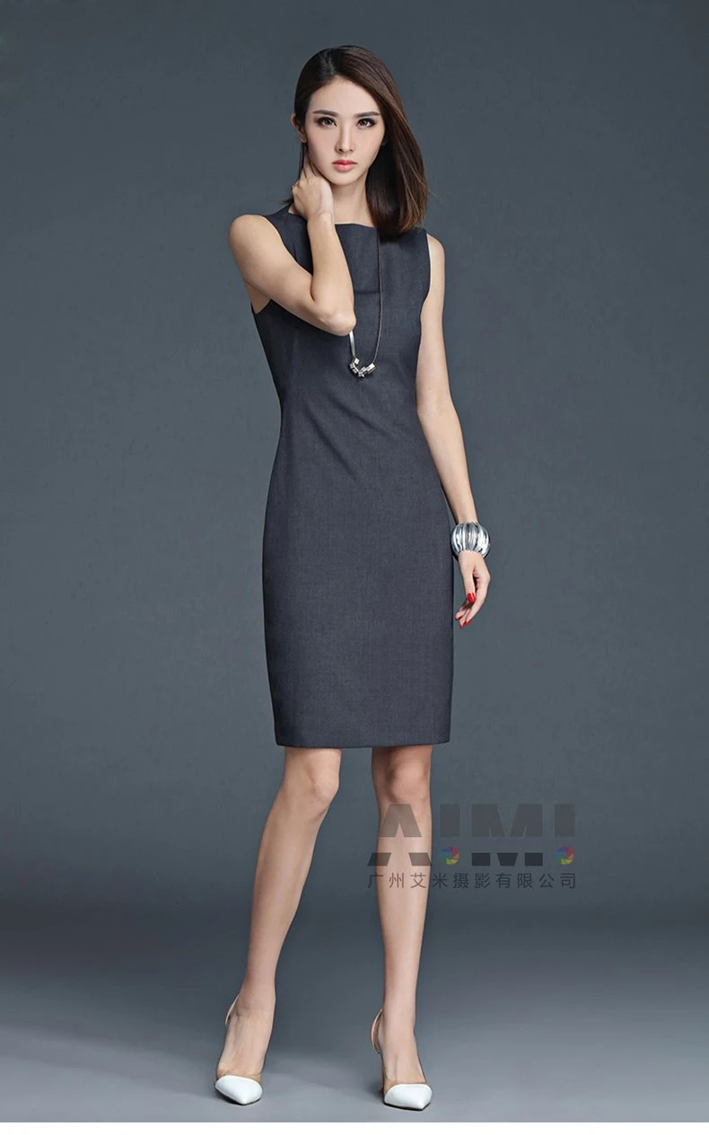 Charcoal business pencil dress with red manicure accent, slight-turn full-length portrait