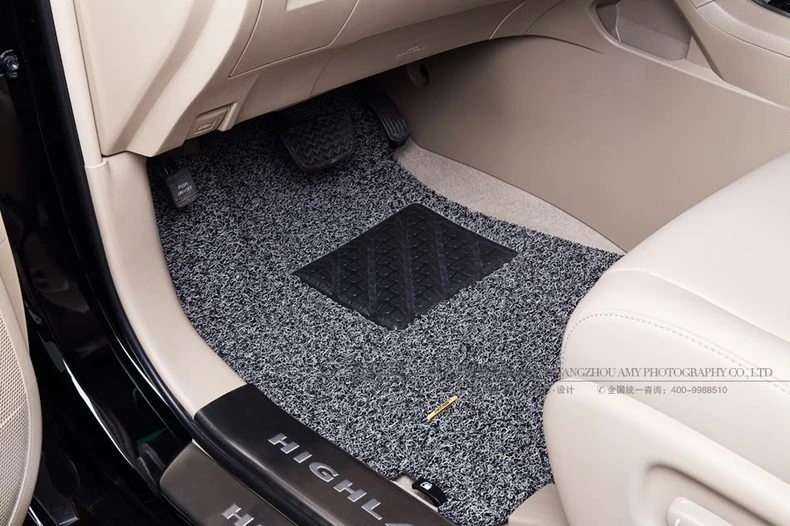 grey speckled coil driver mat in a cream SUV interior
