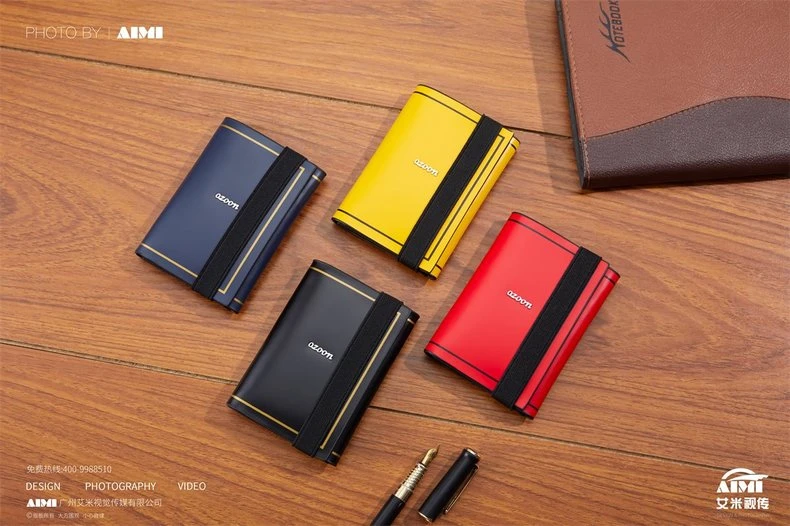 Four card holders in diamond cluster on wood with notebook - color range flat lay photography