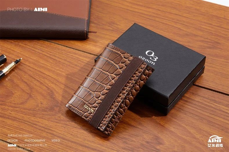 Brown croc-embossed leather card case with branded box - leather goods product photography
