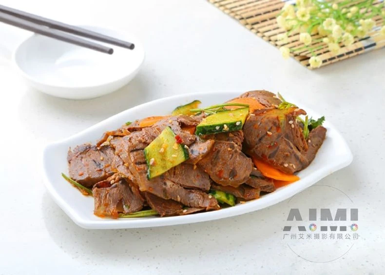 Sliced spicy beef shank with chili oil, sesame and scallion on white