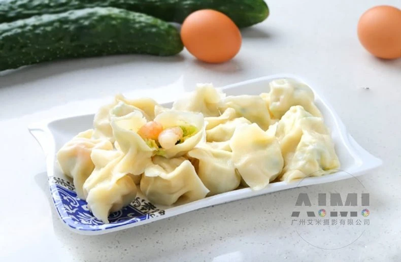 Steamed shrimp cucumber dumplings with translucent skins on a white plate