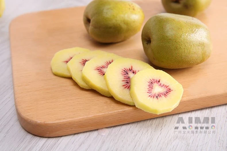 Red-heart kiwi slices on a cutting board showing the flesh pattern