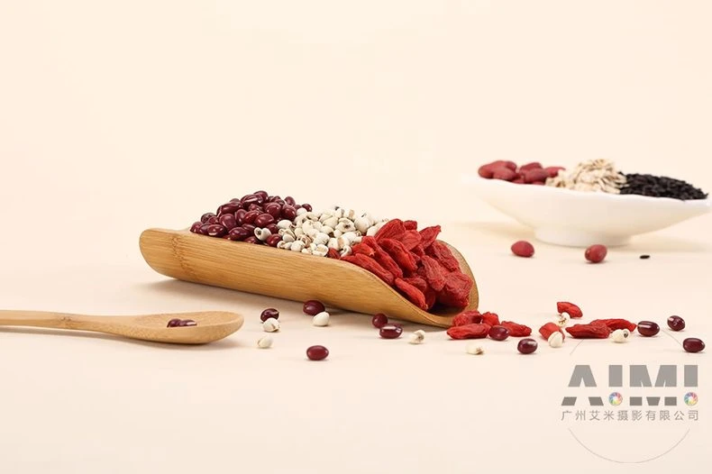 Bulk red beans, coix seeds and goji berries in measured piles on cream