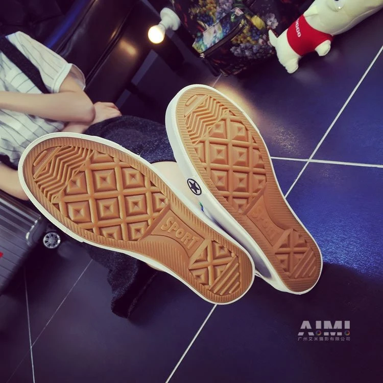 White canvas sneakers with caramel gum-rubber tread shown sole-up in a top-down frame