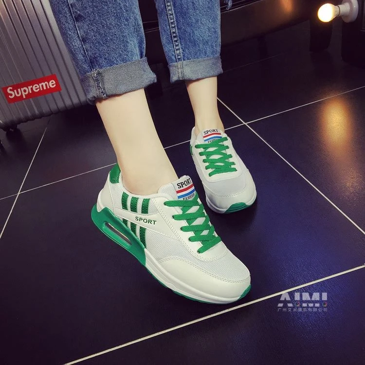 White air-cushion sneakers with bright green accents and a visible transparent air unit, on-foot frame