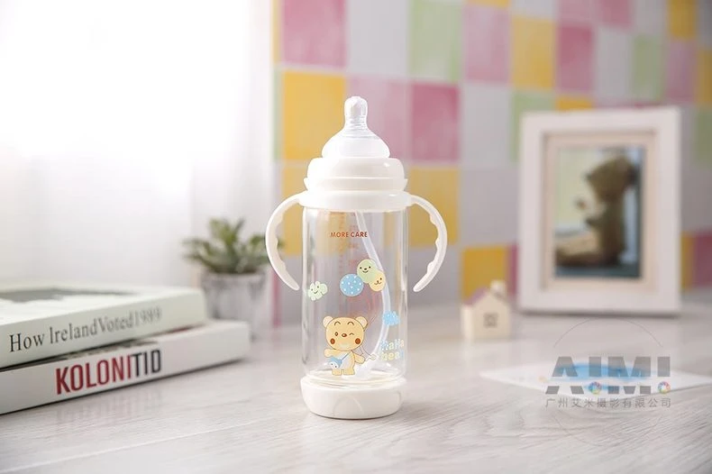 MORE CARE handled baby bottle with bear print against pastel tile wall, shallow focus nursery product photography