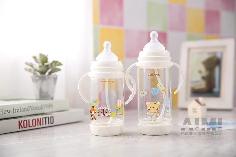 Two MORE CARE anti-colic bottles in small and large capacities with fox and bear prints, nursery pair product photography