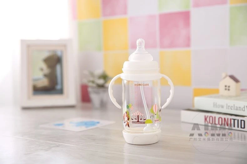 MORE CARE baby bottle with carnival carousel print on pale wood surface, pastel nursery product photography