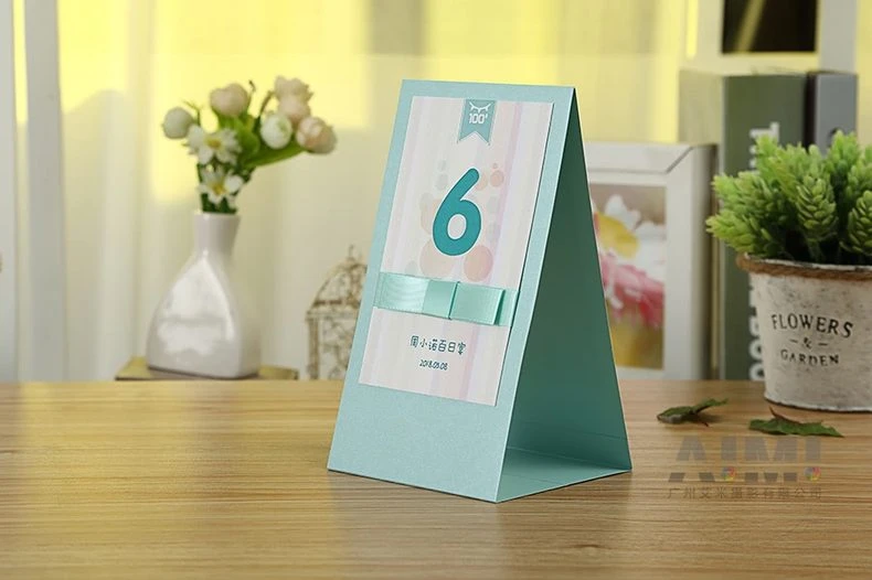 Mint tent table card with number six standing on wooden table - celebration stationery photography